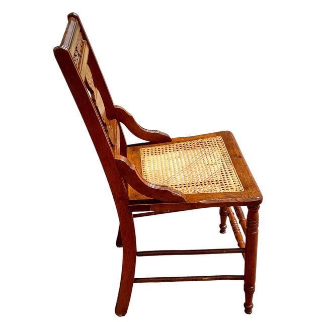 A late 19th century antique solid walnut Victorian Eastlake armchair with a hand carved back, burl walnut panel and hand...