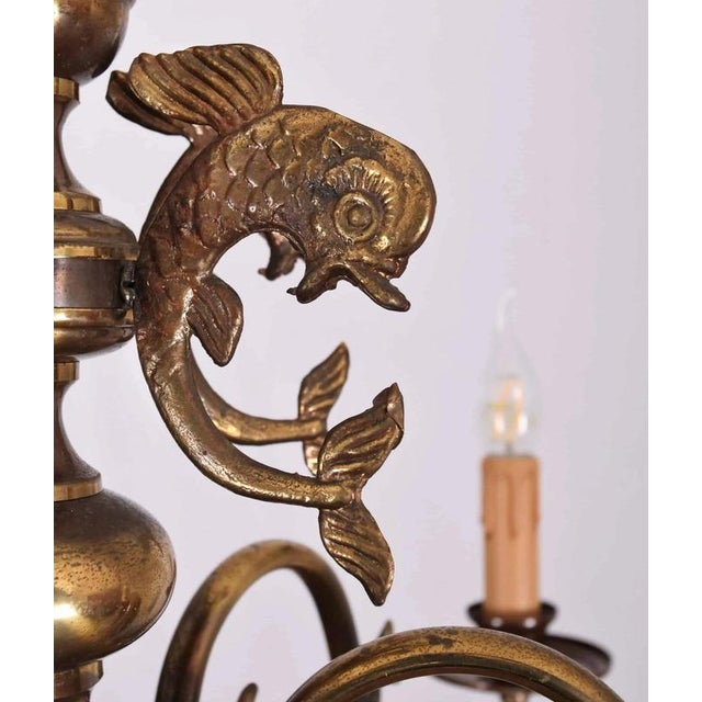 Six-arm chandelier richly decorated with fish motifs. Beautiful patina. Restored electrical installation: new cables,...