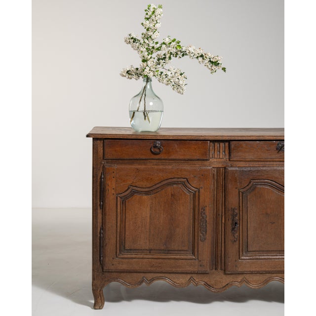Bearing the graceful sensibility of the Louis XV period, this early 19th-century French buffet is a distinguished example...