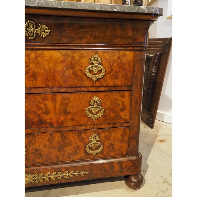 Topped by a one-inch thick marble top, this commode has a beautiful mahogany veneer with flame graining and foliate and...