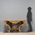Baroque console table in carved and gilded wood. Wooden top with painted faux marble finish, four S-shaped legs richly...