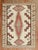 A highly decorative 20th-century American Navajo Rug with a geometric tribal design with pink, camel and brown accents on...