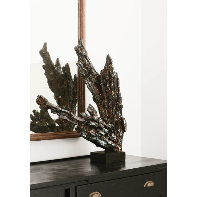 Abstract ceramic sculpture on a dark wood base, France. This intricate sculpture is edgy and dark, yet features a handful...