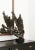 Abstract ceramic sculpture on a dark wood base, France. This intricate sculpture is edgy and dark, yet features a handful...
