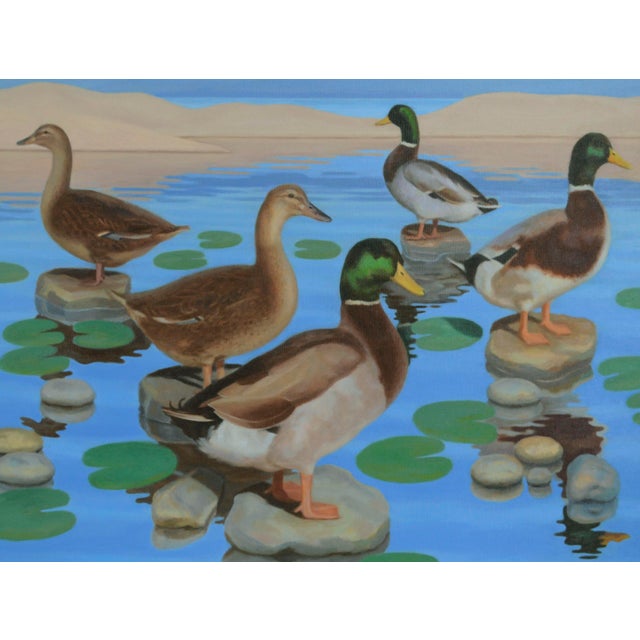 Brightly colored and crisply detailed painting of a group of mallard ducks resting on stones on a calm lake, their dappled...