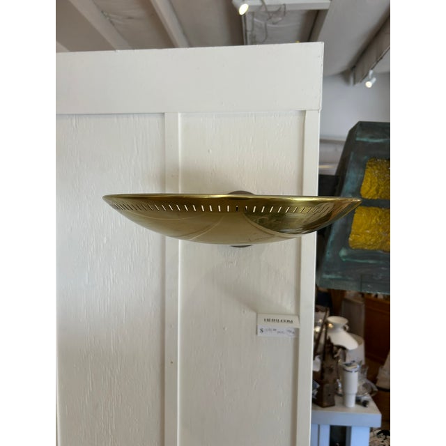 Pair of vintage American Lightolier wall sconces with spun brass saucer shades and perforated detailing around the...