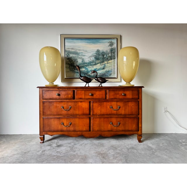 This Vintage Italian Solid Cherry Wood Seven-Drawer Dresser embodies timeless elegance with its rich, warm patina and...