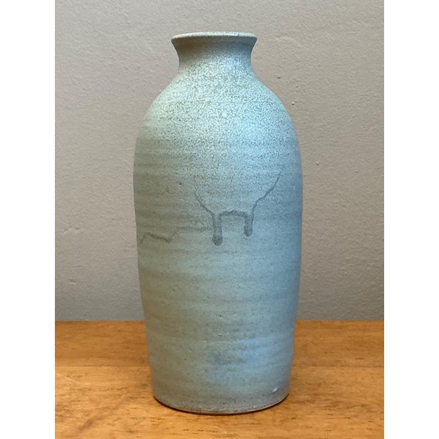 This vintage blue glazed studio pottery vase is a refined example of mid-century ceramic craftsmanship, distinguished by...