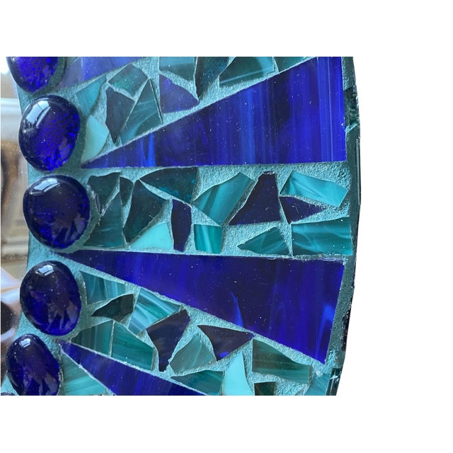 This handcrafted blue and green round mosaic wall mirror features a turquoise frame, adding a touch of uniqueness to any...