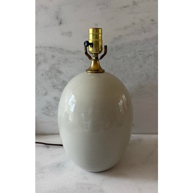 Vintage ceramic table lamp with the perfect simple rounded egg shape, subtle blue gray color and brass socket. This egg...
