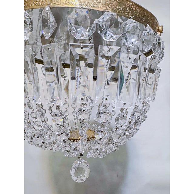 Add a touch of timeless, romantic glamour to your space with this exquisite vintage mid-century tiered brass crystal...