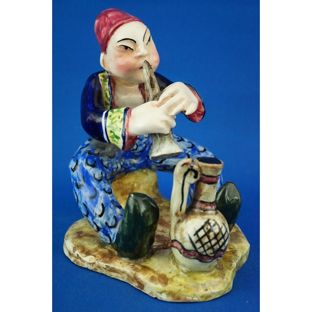 Item : Glazed and vitrified ceramic sculpture, entirely hand-molded and decorated, depicting a young fakir playing the...