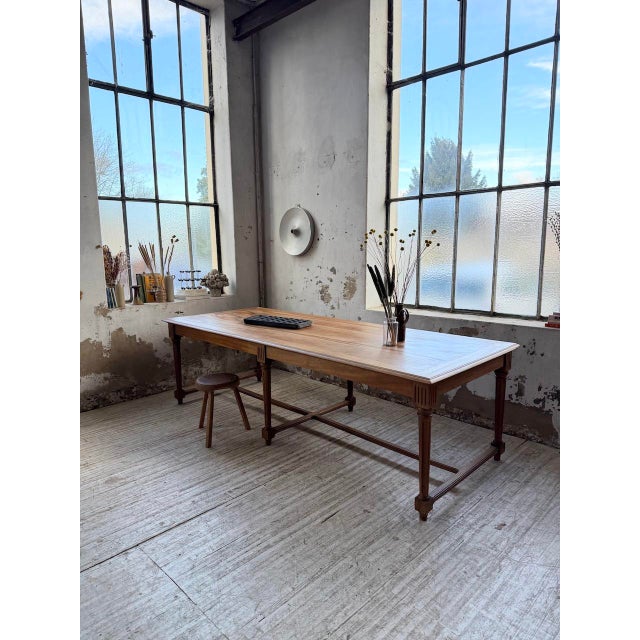 A vintage 1950s walnut farmhouse table, originally from a former town hall. it later spent part of its life in a municipal...