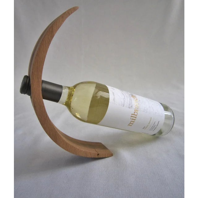 Hand crafted/carved wood wine holder. Signed by the artist (THS) on the base, it has a great sculptural feel. made of...