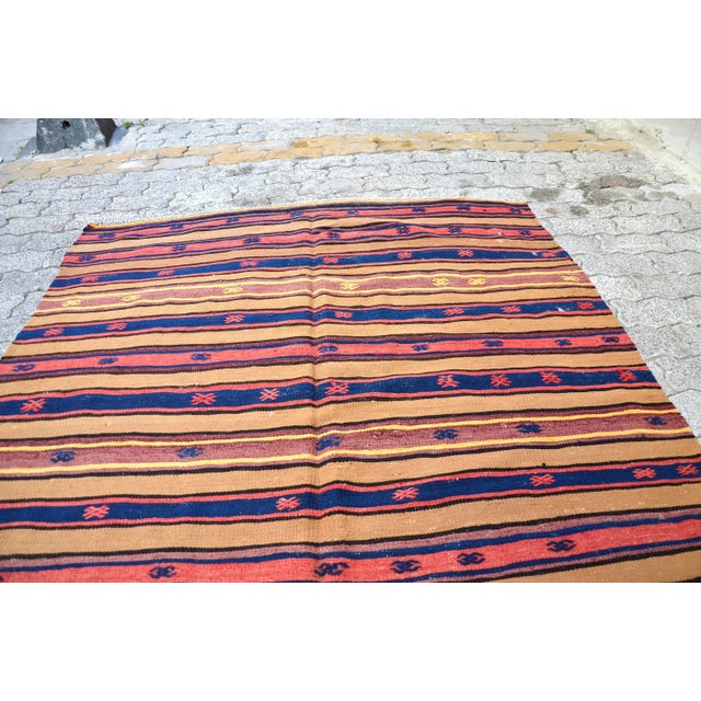 This is a vintage Turkish Anatolian kilim rug from the 1960s. The piece was hand-woven.