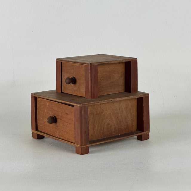 A sweet home accent piece in the form of miniature double level drawers cabinet. An art deco period creation that's great...