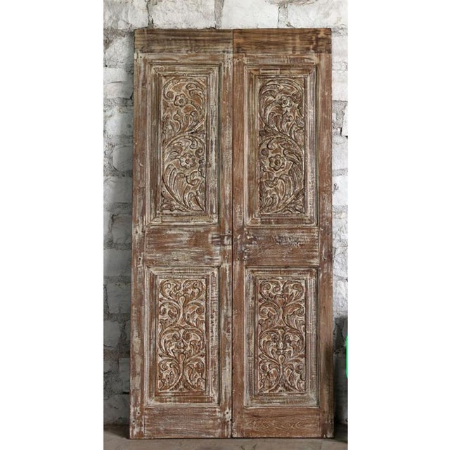 These stunning antique double doors are hand-carved from reclaimed solid wood and feature intricate floral motifs that...