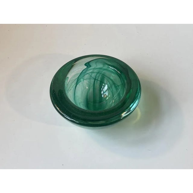 Thick and heavy conical art glass bowl from Kosta Boda in Sweden. It was designed by Anna Ehrner in the mid 1980s. The...