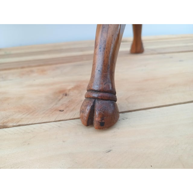 Classic Art Deco Coffee Table with Goat Feet from Baker Furniture. Features goat hooves, MCM intersecting leg design and a...