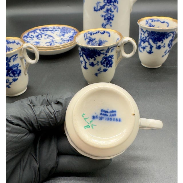 Rare antique porcelain chocolate pot set/demitasse set. Set has one full pitcher, hairline crack noted, four cups and...