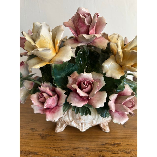 A lush and romantic Capodimonte porcelain floral centerpiece, hand-crafted in Italy and marked on the underside with the...