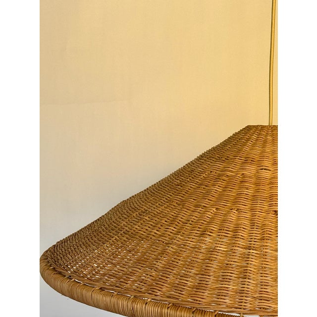 Great large rattan pendant ready for installation! Lovely woven rattan detail with fabric cord and brass canopy. unsigned