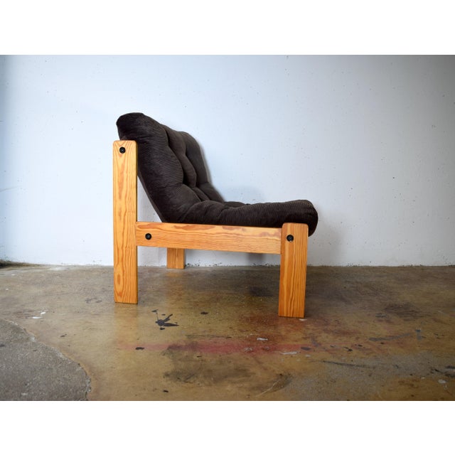 This is a 1970s pine/corduroy armchair in a brutalist style. The upholstery is very comfortable, and the pine frame is...
