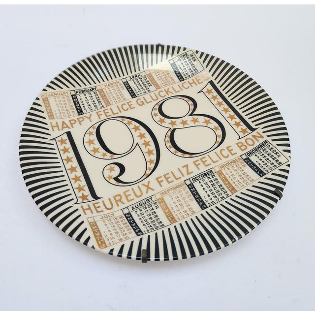Ceramic Calendar Plate Piero Fornasetti Milano, marked on the back 14th Calendar Plate 1981 White ceramic with gold and...