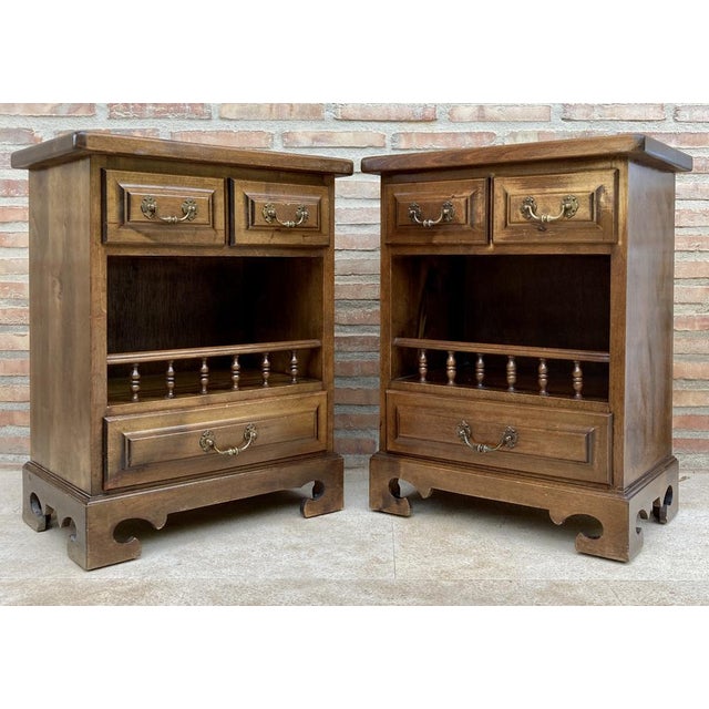 Pair of 20th century Spanish bedside tables with two small drawers, an open shelf with a pilaster railing and a low drawer...