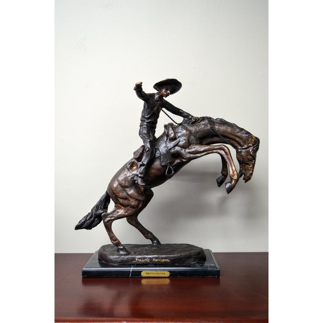 Bronco Buster, a cast bronze sculpture after American artist Frederic Remington on marble base. Filled with a tremendous...