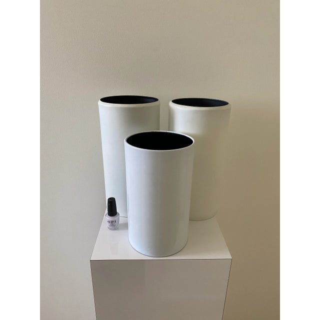 Three vintage white powder coated metal cylinder canister lights. Two large lamps 11 7/8” tall by 6 1/4” across the top....