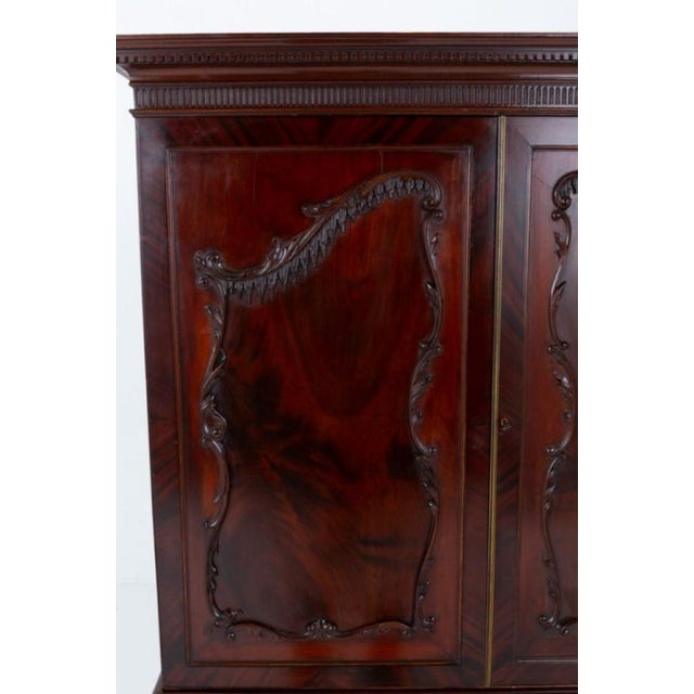 Wonderful mahogany Chippendale style linen press This linen press stands upon bracket feet Having an arrangement of 3...
