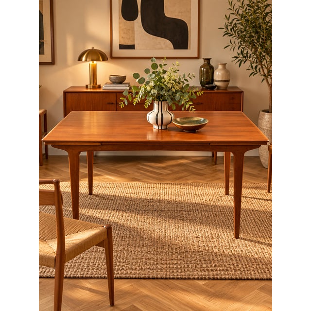Vintage Scandinavian dining table dating from the 1970s, crafted from teak with warm amber hues and a highly decorative...