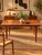 Vintage Scandinavian dining table dating from the 1970s, crafted from teak with warm amber hues and a highly decorative...