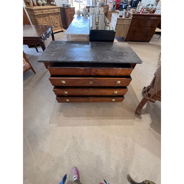18th Century French Empire Commode from France. Made of Mahogany, with a black marble top, the wood has been finished with...