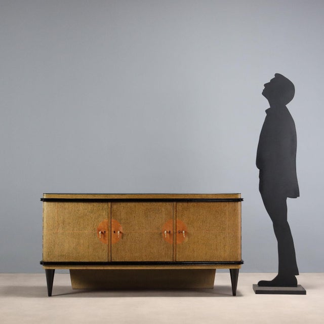1940s sideboard designed to also function as a bar cabinet, featuring a functional and refined design. The structure is...