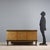 1940s sideboard designed to also function as a bar cabinet, featuring a functional and refined design. The structure is...
