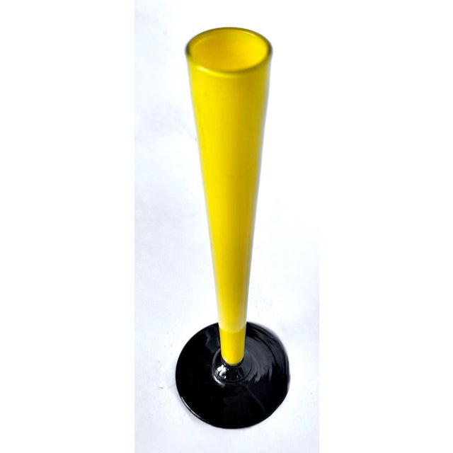 Vintage mid-century modern Murano glass tulip vase with yellow blown glass vase body and black glass flanged base. No...
