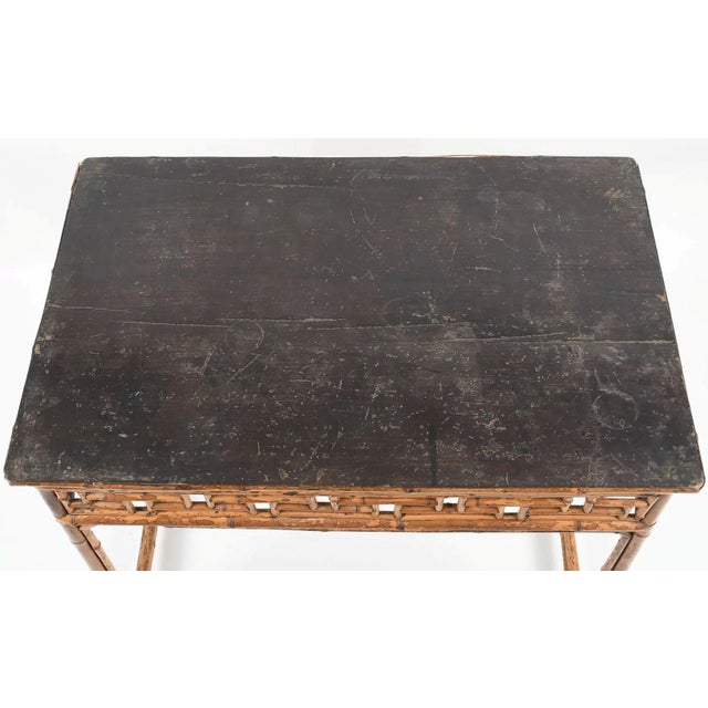 A beautifully composed 19th century bamboo and rattan table, exemplifying the refined yet relaxed elegance of the...