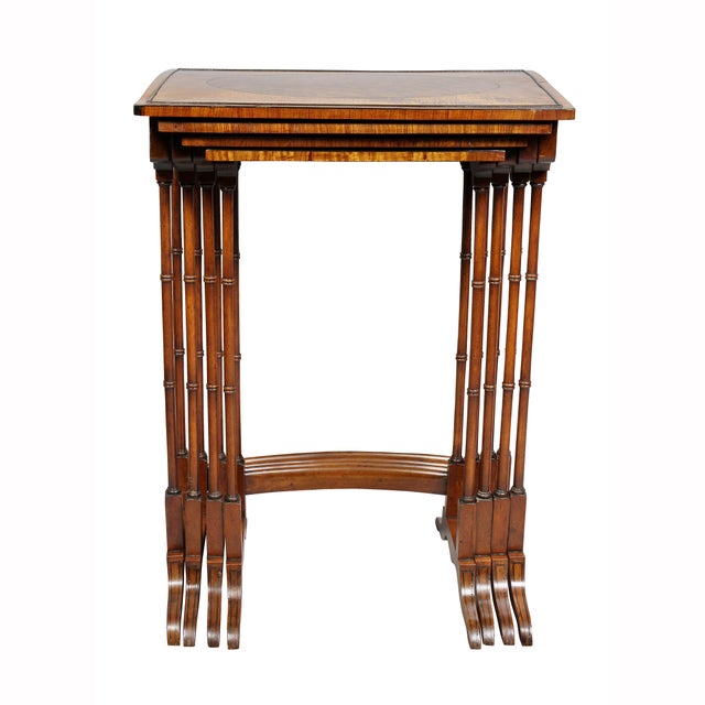 Each graduated table with a rectangular top with oval panel and satinwood border, bamboo turned legs, saber legs.