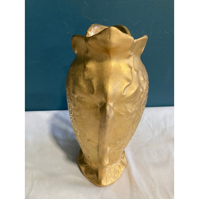 Stunning unique vase with mismatched handles. It has gold swirls and is lovely.