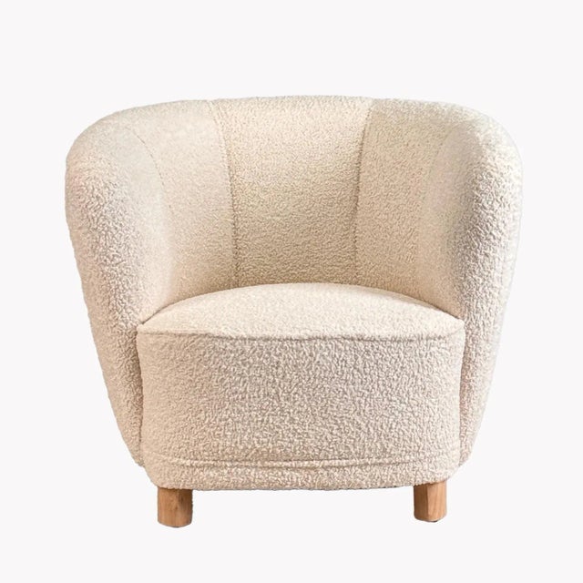 An original 1940's design from Denmark, this rounded tub chair is newly upholstered in a light cream boucle fabric with...