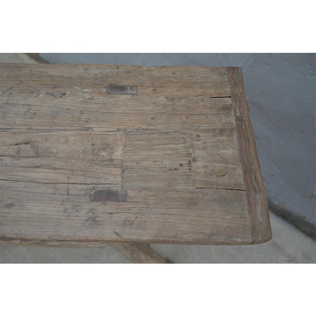 A beautifully rustic console table crafted from solid pinewood, dating to the first half of the 20th century. The long,...