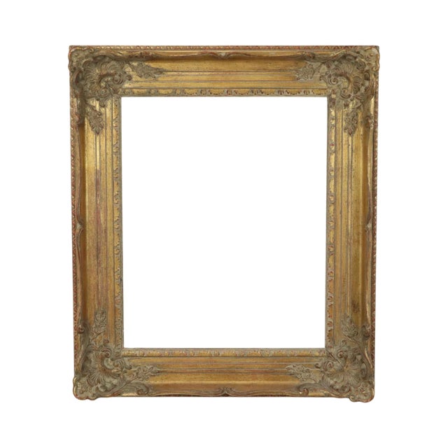Antique pine frame gilded with gold leaf, featuring acanthus decoration on the corners, floral decoration, and a pattern...