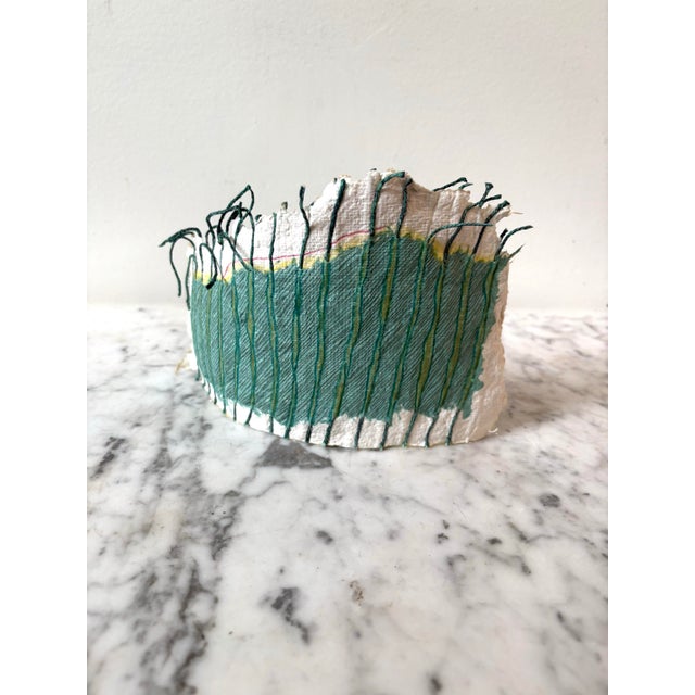 Barbara Beck Free From Hand Shaped paper Sculpture featuring aqua paint and green yarn. Barbara Beck artist. Beck’s work...