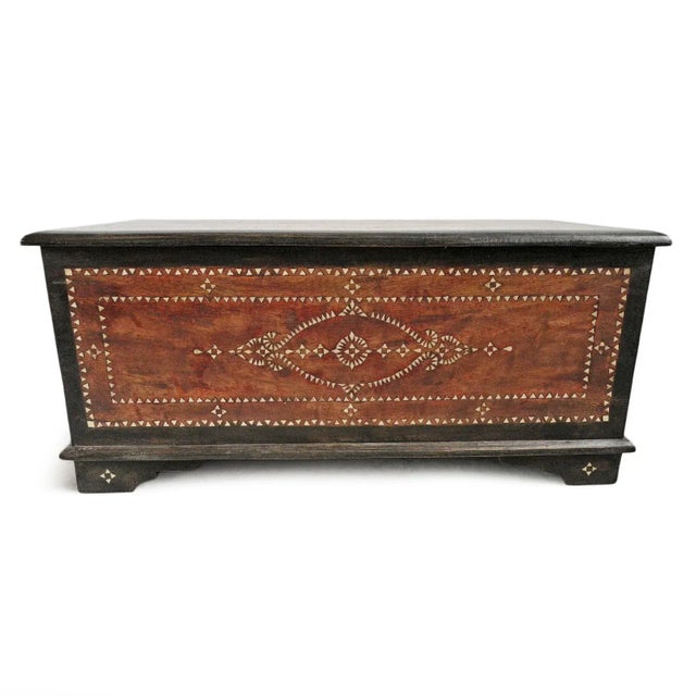 Vintage wood storage trunk. Traditional Balinese mother of pearl design patterns. Beautiful warm stained teak with black...