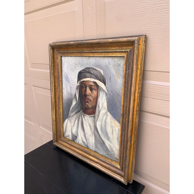 A compelling late 19th-century oil on board portrait depicting a young Middle Eastern sheikh, masterfully rendered with...