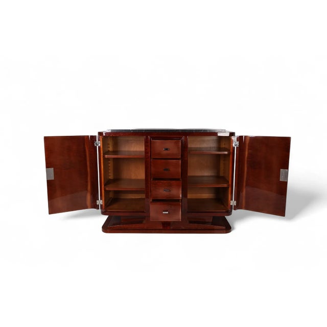 The product is a vintage 1920s French Art Deco marble top walnut sideboard buffet, featuring a unique and elegant design....