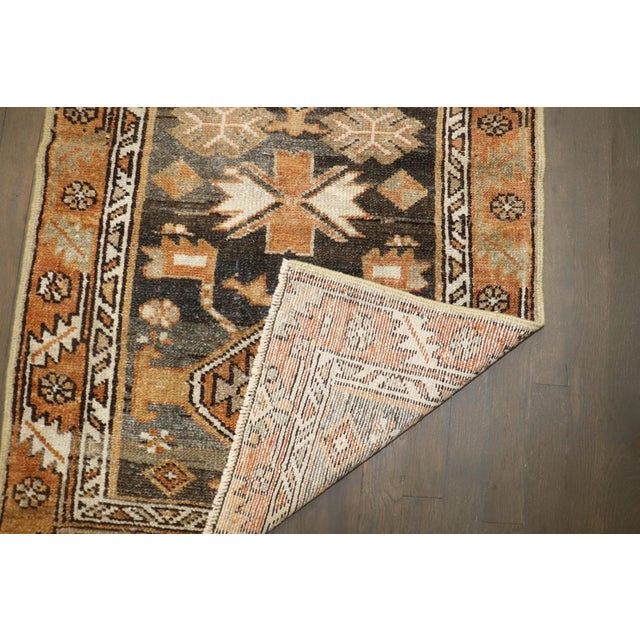 An early 20th century predominantly brown tone persian heriz rug
