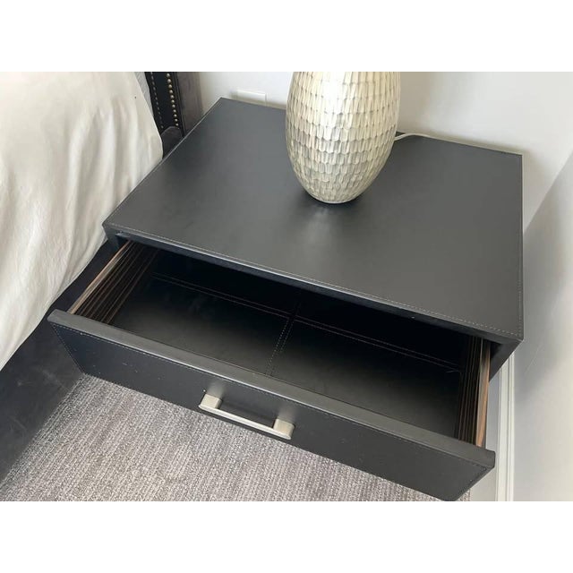 Cantoni Collection Merit two-drawer nightstand in black leather with matching stitching, brushed stainless steel pulls and...